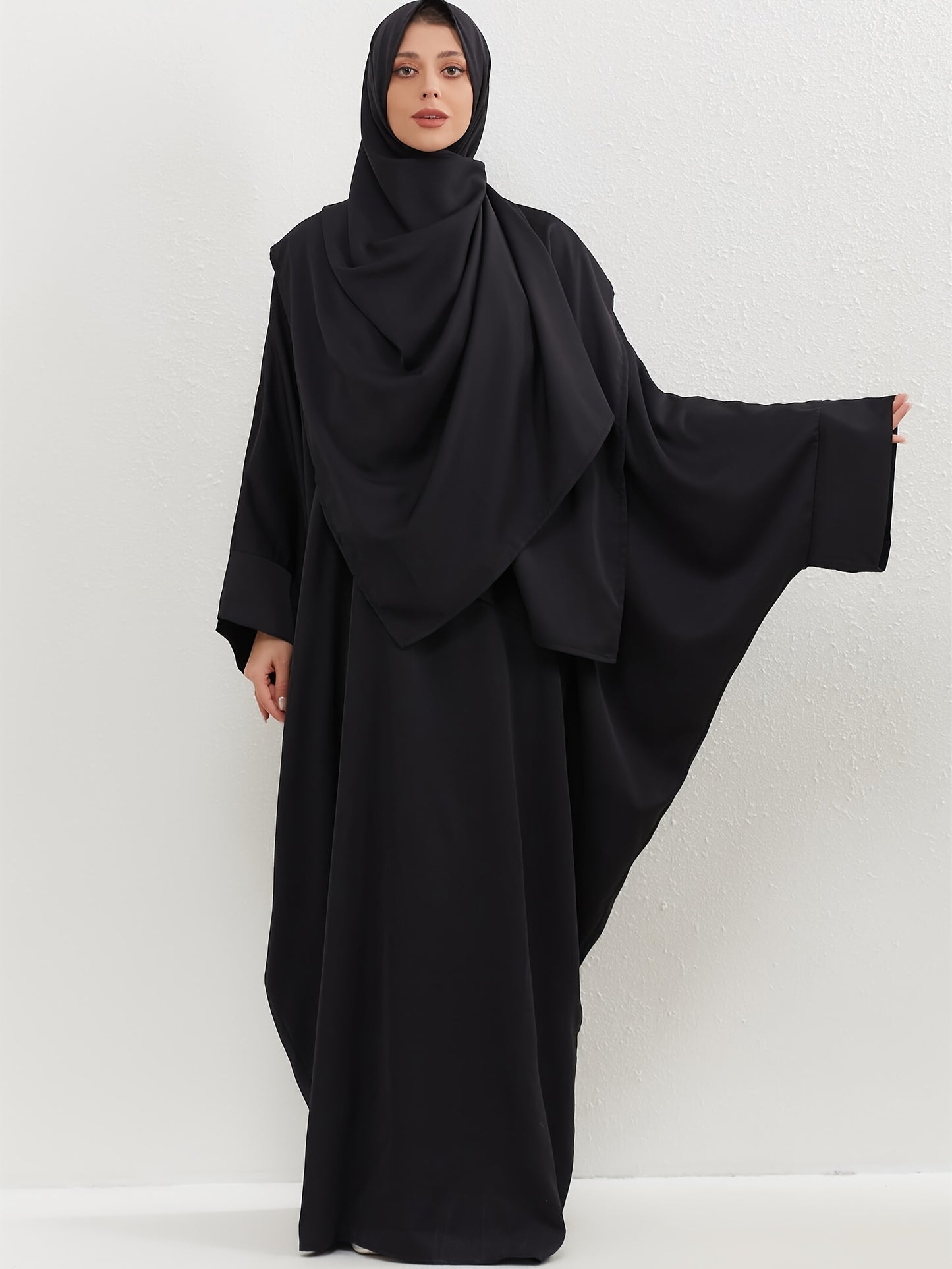 Set of 2 Muslim Jibab Abaya Dresses Featuring a Crew Neck And Batwing Sleeves, Including Hijabs, Designed for Women. These Loose-Fitting Maxi Dresses Are Suitable for Prayer And Everyday Wear.